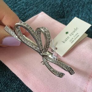 Kate Spade “All Tied Up” Hinge Bangle in Silver